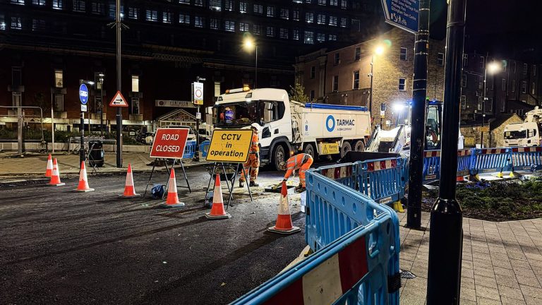 workers resurfacing a road with fresh asphalt